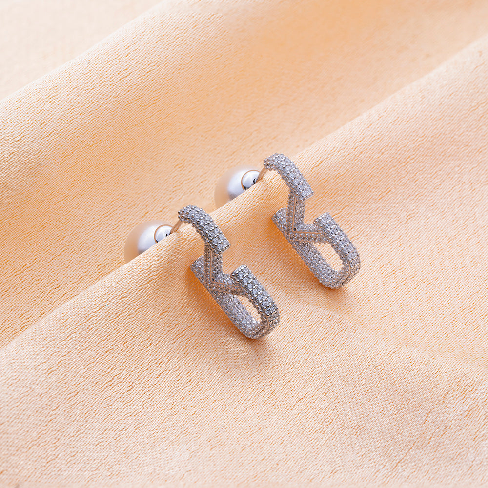 Reegalia SparkLite 925 Silver Pave Huggie Earrings.